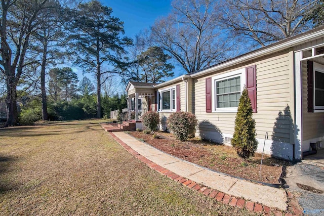 view of side of property with a yard