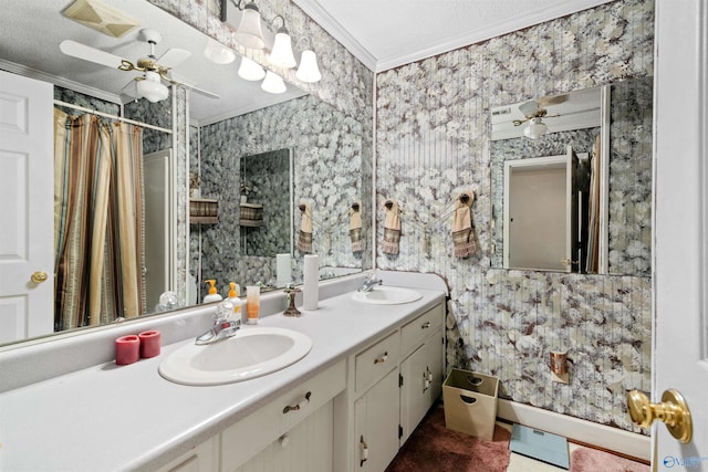 bathroom with crown molding, vanity, and a textured ceiling