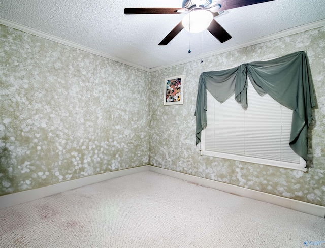 carpeted spare room featuring a textured ceiling, ceiling fan, and ornamental molding