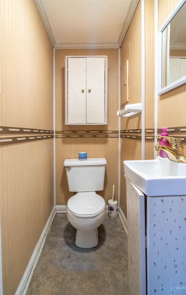 bathroom with a textured ceiling, sink, toilet, and crown molding