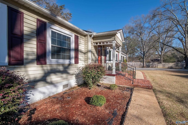 view of side of home featuring a lawn