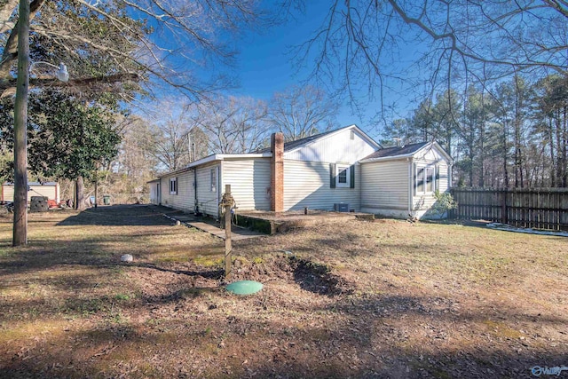 view of side of home featuring a lawn