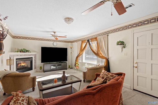 living room featuring light colored carpet, ornamental molding, and a textured ceiling