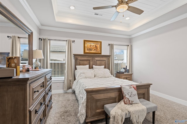 carpeted bedroom with a raised ceiling, ornamental molding, wooden ceiling, and ceiling fan