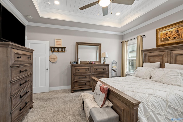 bedroom featuring a tray ceiling, ornamental molding, light colored carpet, and ceiling fan