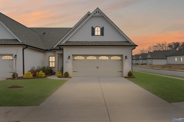 view of front of house featuring a garage and a lawn