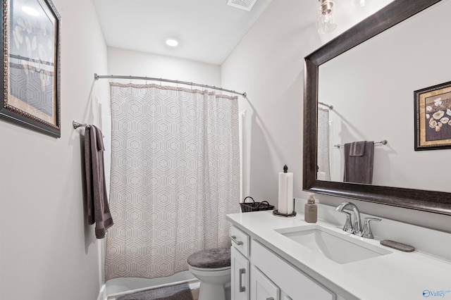 bathroom with vanity, toilet, and a shower with shower curtain