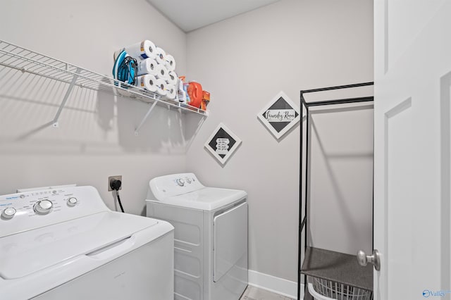 washroom with washing machine and clothes dryer