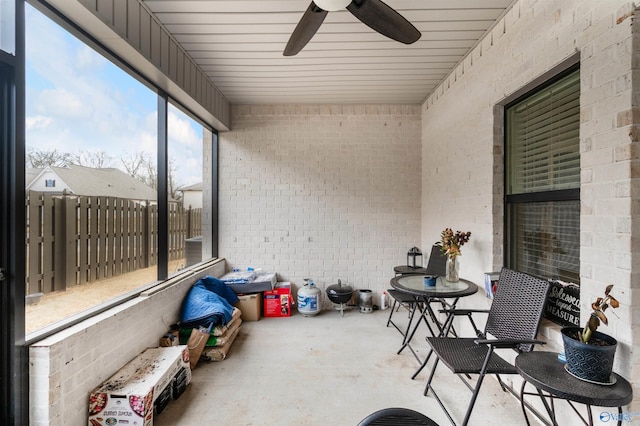 sunroom featuring ceiling fan