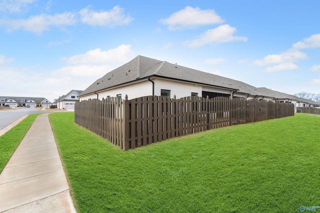 view of property exterior with a lawn