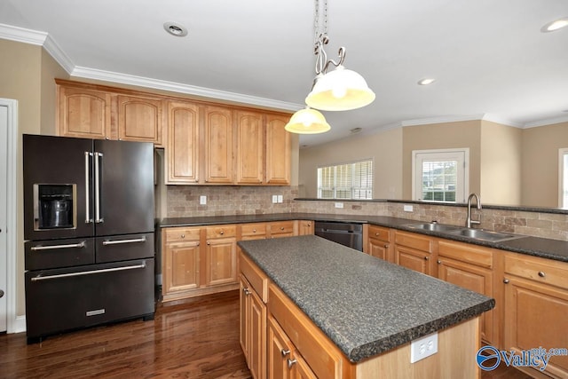 kitchen featuring a sink, ornamental molding, dark countertops, dishwashing machine, and high end fridge