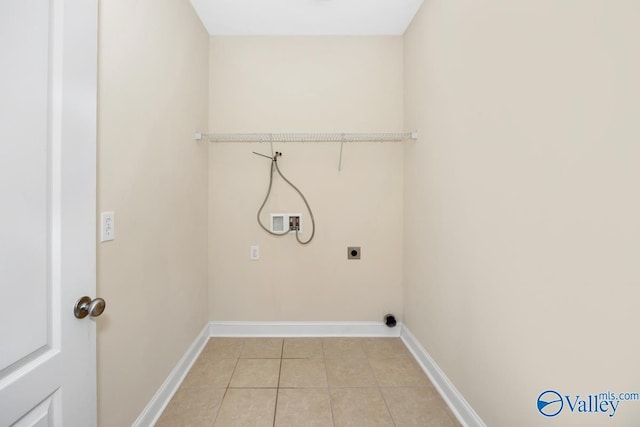washroom with hookup for an electric dryer, baseboards, light tile patterned floors, laundry area, and hookup for a washing machine