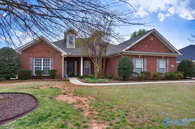 view of front of home featuring a front yard and brick siding