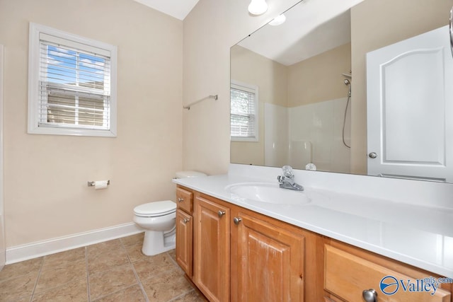 full bathroom featuring a shower, vanity, baseboards, and toilet