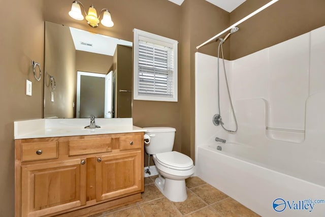bathroom with visible vents, washtub / shower combination, toilet, vanity, and tile patterned floors