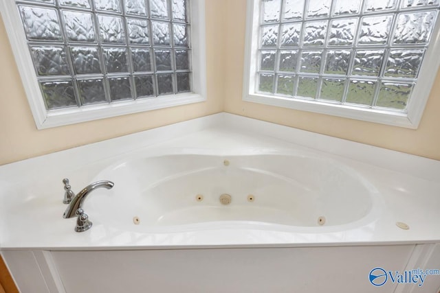 bathroom featuring a tub with jets