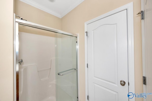 full bathroom with ornamental molding and a shower stall