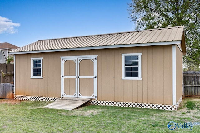 view of shed featuring fence