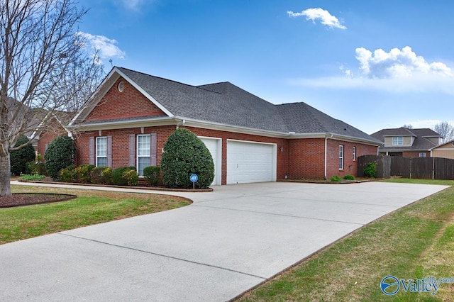 view of front of property with a front yard, a garage, fence, concrete driveway, and brick siding