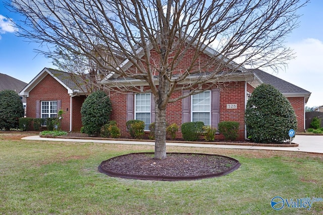 ranch-style home featuring a front lawn and brick siding