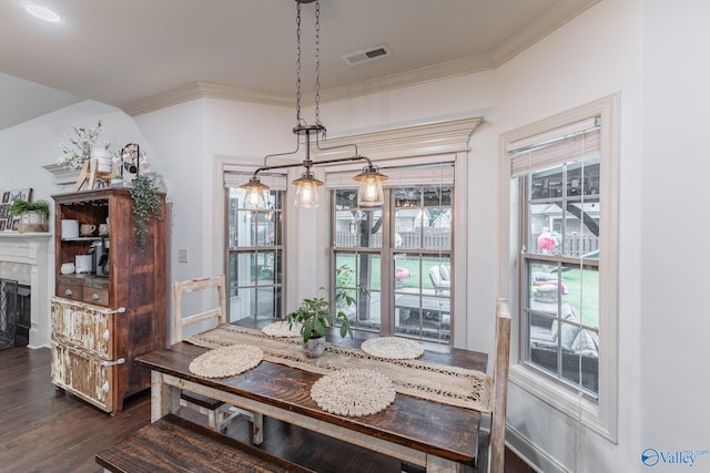 dining area featuring ornamental molding, a fireplace, dark wood-style floors, and visible vents