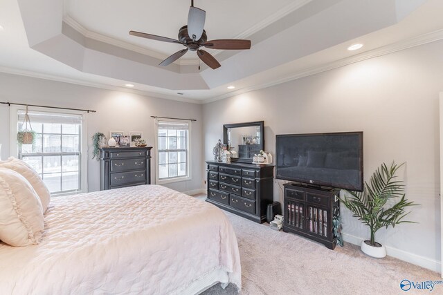 bedroom with baseboards, ornamental molding, carpet, and a tray ceiling