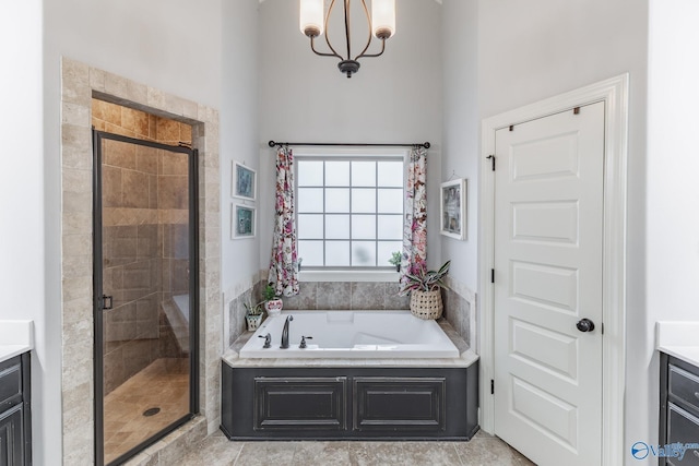 bathroom featuring vanity, a garden tub, and a stall shower