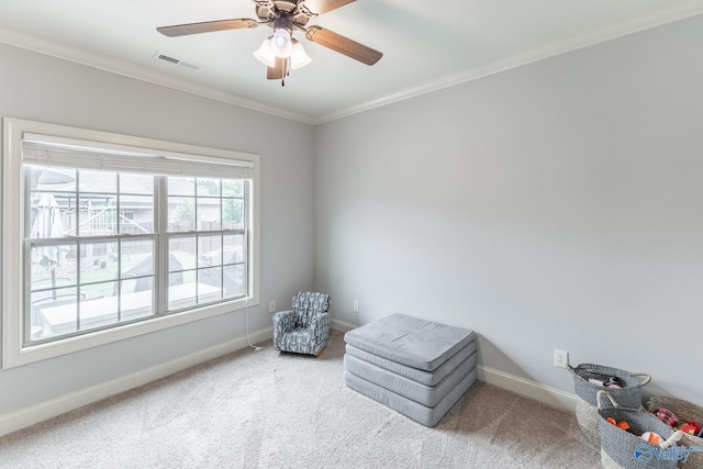 unfurnished room with a ceiling fan, visible vents, crown molding, carpet floors, and baseboards