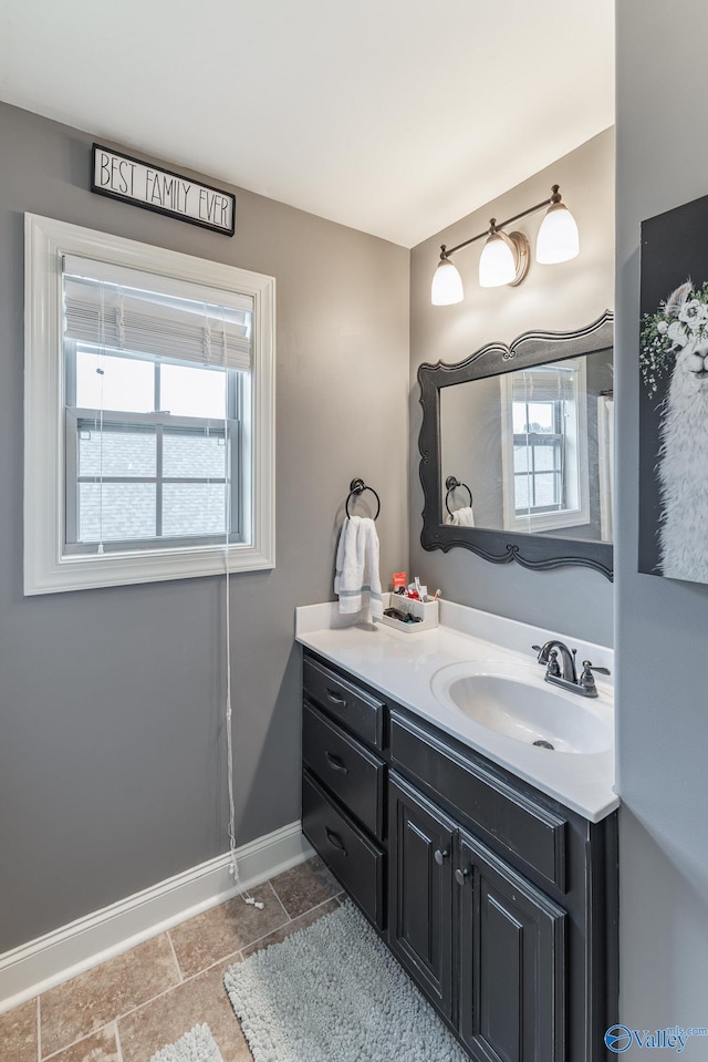 bathroom featuring baseboards and vanity