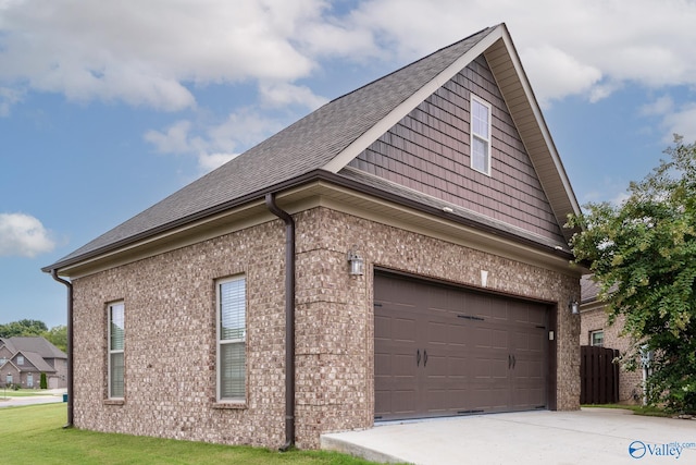 view of property exterior featuring a lawn and a garage