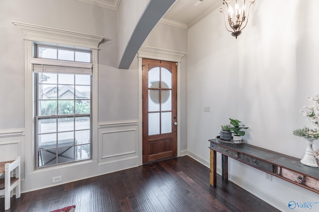 entryway featuring wainscoting, dark wood-style flooring, plenty of natural light, and ornamental molding