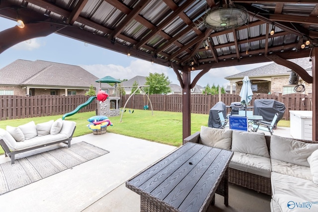 view of patio / terrace with a gazebo, outdoor lounge area, a fenced backyard, and a playground