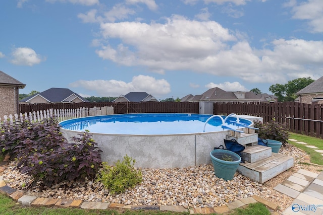 view of pool with a fenced backyard and a fenced in pool