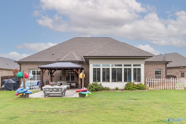 back of property featuring brick siding, a gazebo, an outdoor living space, and a patio area