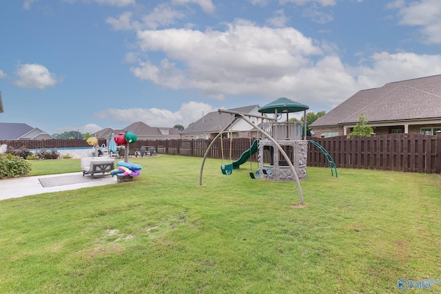 view of play area with a lawn and a fenced backyard