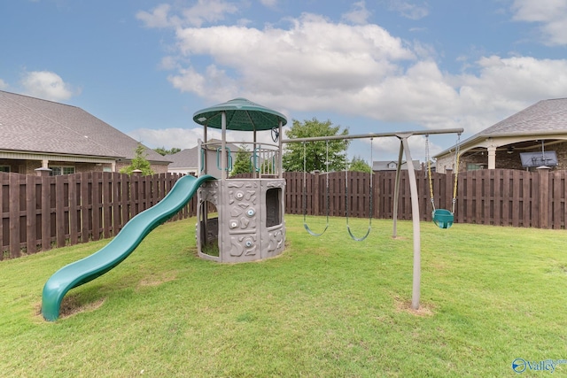 view of playground featuring a fenced backyard and a lawn