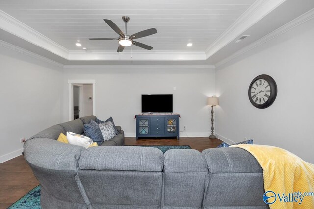 living room with ceiling fan, crown molding, and a tray ceiling