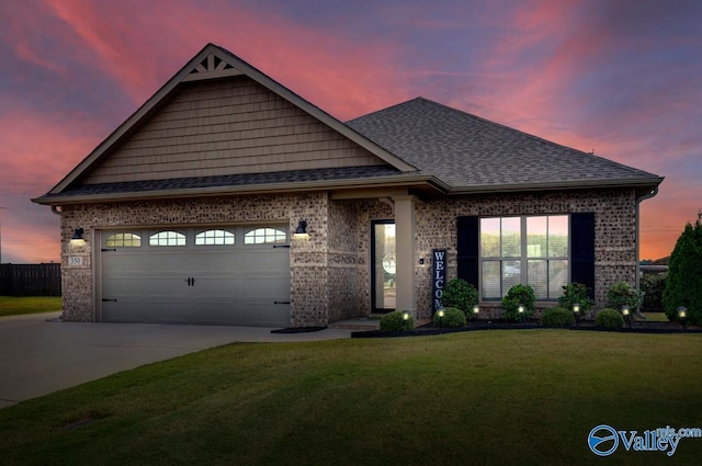 view of front facade with a garage, brick siding, concrete driveway, and a yard