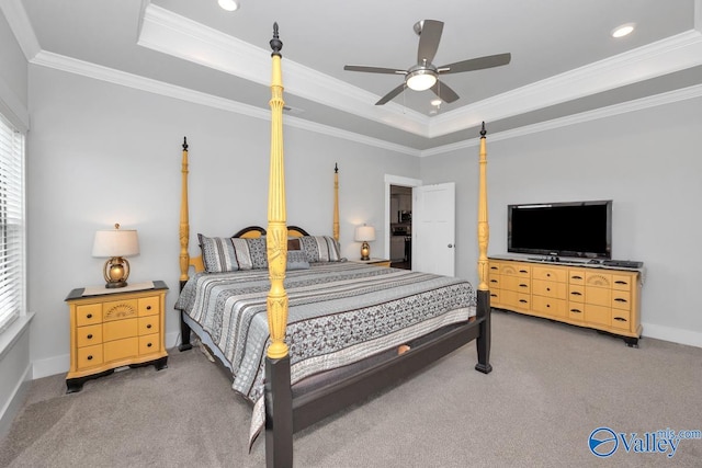 carpeted bedroom with ceiling fan, a raised ceiling, and ornamental molding