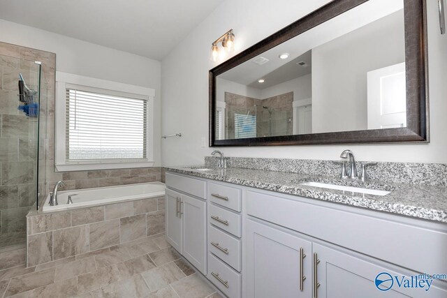 bathroom featuring tile patterned flooring, vanity, and independent shower and bath