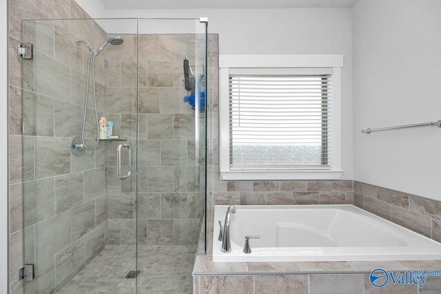 bathroom featuring shower with separate bathtub and plenty of natural light