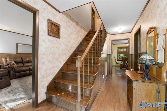 19660 Cox Rd, Athens, AL 35611 - stairway featuring wallpapered walls, baseboards, crown molding, and wood finished floors