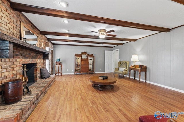 19660 Cox Rd, Athens, AL 35611 - living area with ceiling fan, a fireplace, wood finished floors, baseboards, and beam ceiling