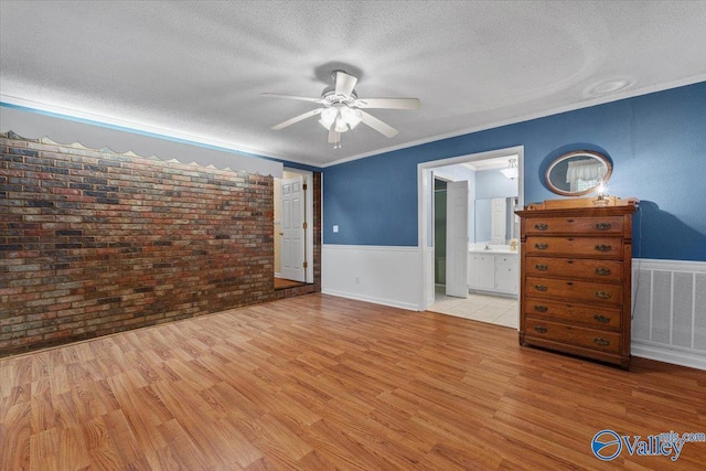 19660 Cox Rd, Athens, AL 35611 - bedroom with brick wall, visible vents, a textured ceiling, and wood finished floors