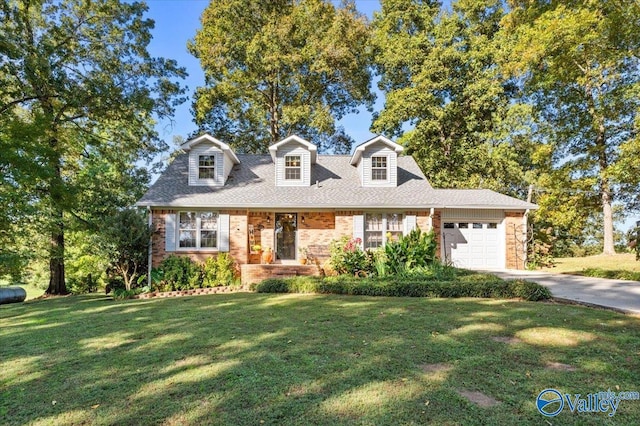 19660 Cox Rd, Athens, AL 35611 - cape cod house with driveway, an attached garage, and a front lawn