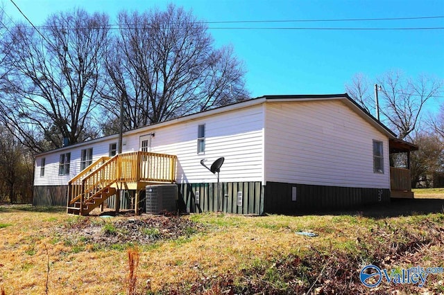 exterior space with central AC and a wooden deck