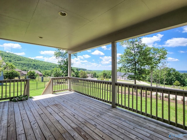 wooden terrace featuring a lawn