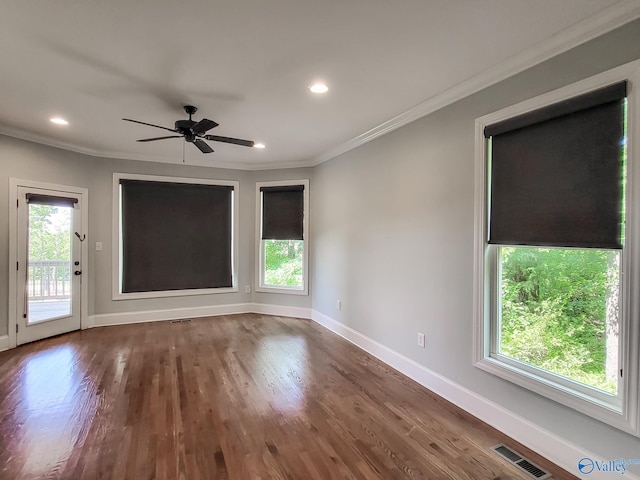 unfurnished room featuring crown molding, dark hardwood / wood-style floors, and ceiling fan