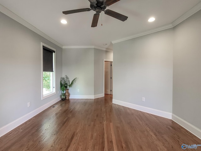 spare room featuring ornamental molding, dark wood-type flooring, and ceiling fan