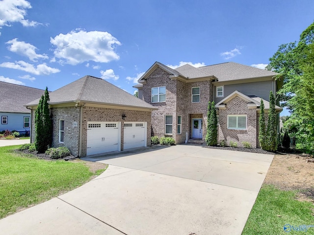 view of front of home with a garage and a front lawn